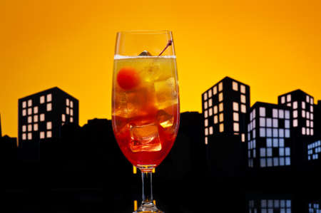 Metropolis Tequila Sunrise cocktail in city skyline settingの写真素材