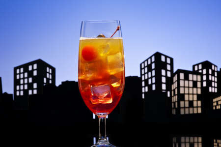 Metropolis Tequila Sunrise cocktail in city skyline settingの写真素材