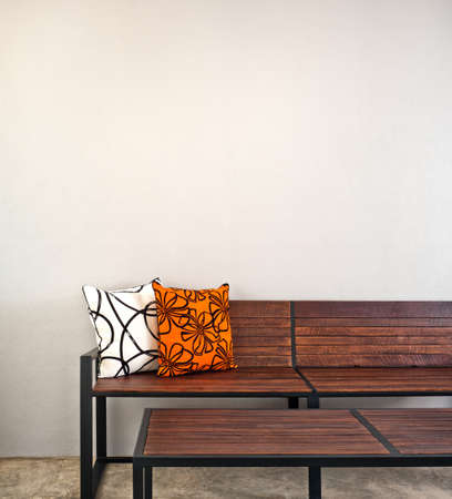 Garden bench as interior furniture with two pillowの写真素材
