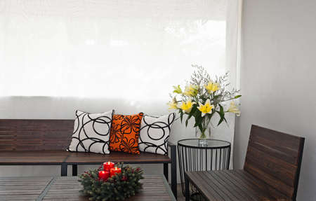 Patio lounge with garden bench and flower decorationの写真素材