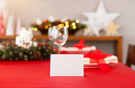 Christmas dinner table setting with name card in redの写真素材