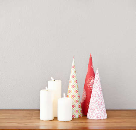 Paper cones and lit candles on a side board as decoの写真素材
