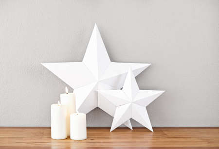 Stars and lit candles on a side board as decoの写真素材