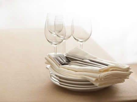 Wine glasses, cutlery, plates and napkins on a tableの写真素材