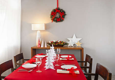 Christmas dinner table setup with decoration on the side boardの写真素材