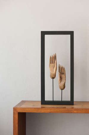Buddhas hands on beige brown side board