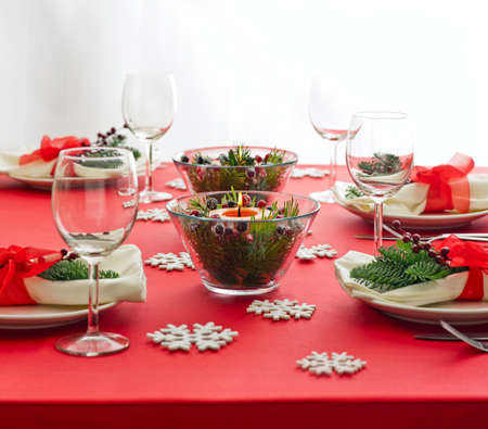 Red Christmas dinner table setup with snow flake decorationの写真素材