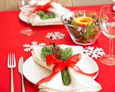 Red Christmas dinner table setup with snow flake decorationの写真素材