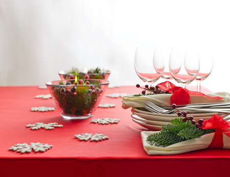 Red Christmas dinner table setup with snow flake decorationの写真素材