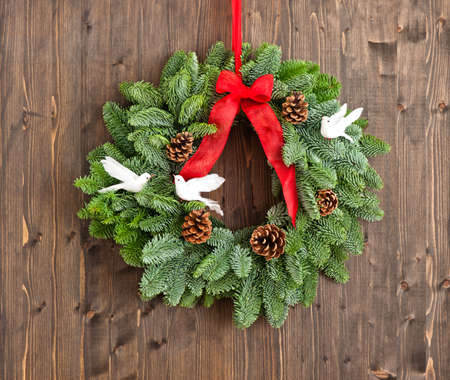 Advent wreath with red ribbon over wooden wallの写真素材