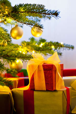Christmas tree decorated with presents in living roomの写真素材