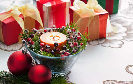 Christmas Presents with red bauble and candle decorationの写真素材