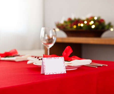 Christmas dinner table setting with name card in redの写真素材