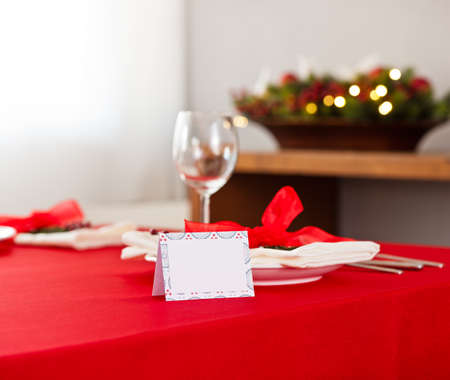 Christmas dinner table setting with name card in redの写真素材