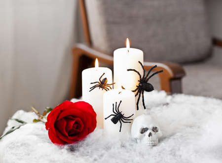 Grey upholstered chair in Halloween setting with candlesの写真素材
