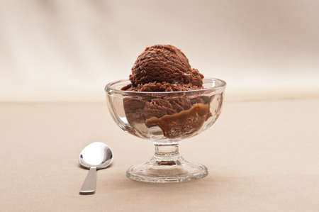 chocolate ice cream over a beige backgroundの写真素材