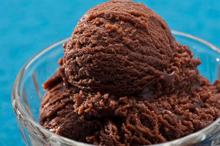 chocolate ice cream over a blue backgroundの写真素材