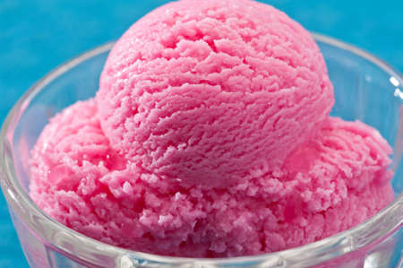 raspberry ice cream over a blue backgroundの写真素材