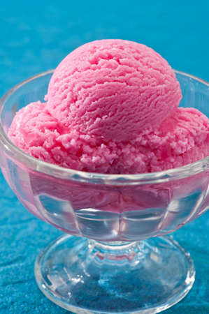 raspberry ice cream over a blue backgroundの写真素材