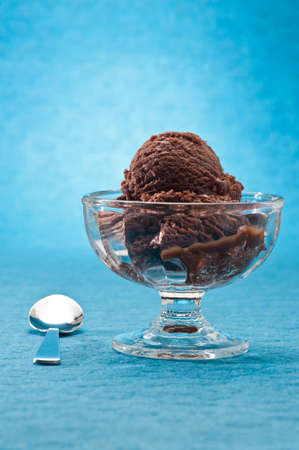 chocolate ice cream over a blue backgroundの写真素材