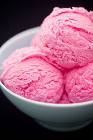 Strawberry ice cream cup over black background
の写真素材
