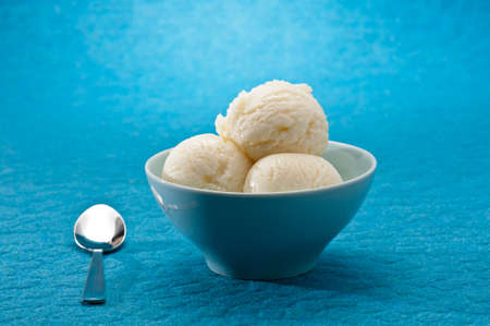 Ice Cream cup isolated over blue backgroundの写真素材