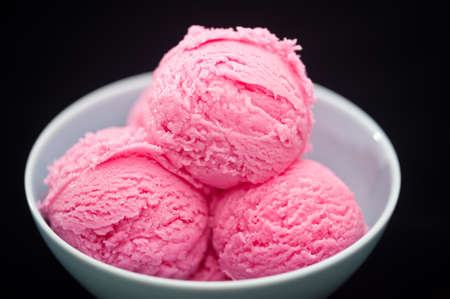 Strawberry ice cream cup over black background
の写真素材