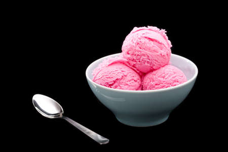 Strawberry ice cream cup over black background