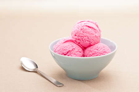 Strawberry ice cream cup over beige background
の写真素材