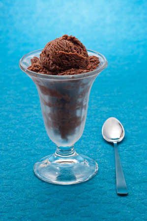 Chocolate ice cream cup over blue backgroundの写真素材