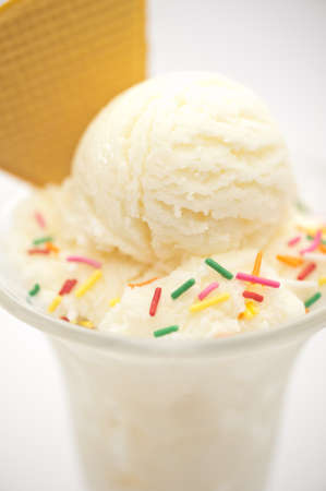Vanilla ice cream cup with wafer over bright backgroundの写真素材