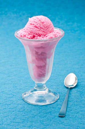 Strawberry ice cream cup over blue backgroundの写真素材