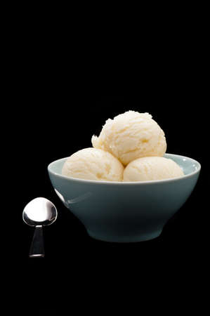 Vanilla ice cream cup with wafer over black backgroundの写真素材
