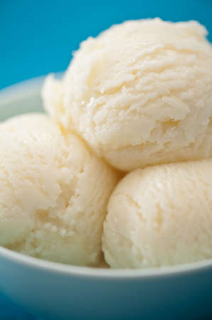 Vanilla ice cream cup over blue backgroundの写真素材
