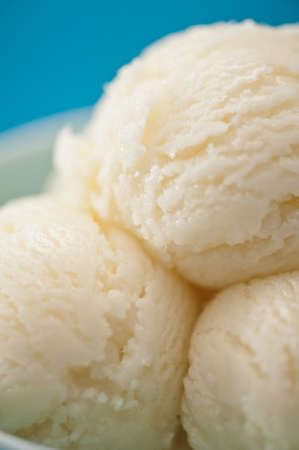 Vanilla ice cream cup over blue backgroundの写真素材