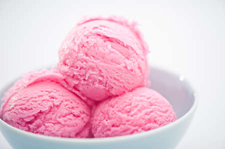Raspberry ice cream cup over bright backgroundの写真素材
