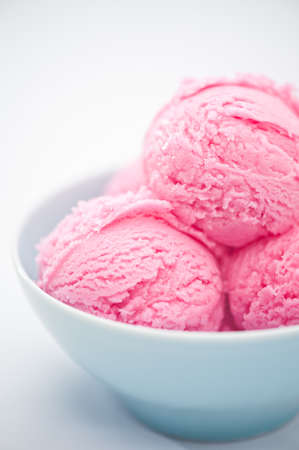 Raspberry ice cream cup over bright backgroundの写真素材