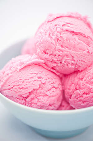Raspberry ice cream cup over bright backgroundの写真素材