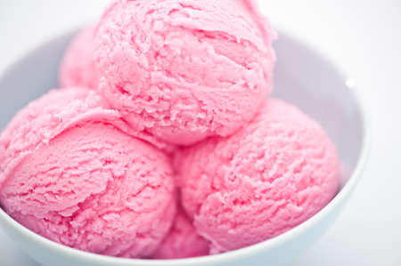 Raspberry ice cream cup over bright backgroundの写真素材
