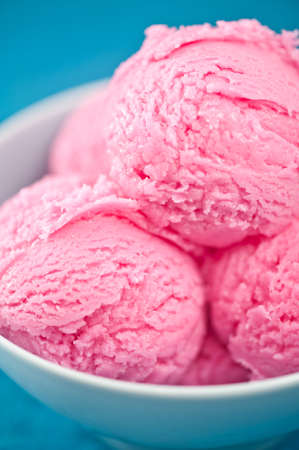 Raspberry ice cream cup over bBLUE backgroundの写真素材