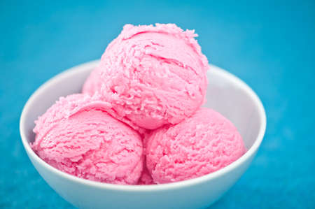 Raspberry ice cream cup over bBLUE backgroundの写真素材