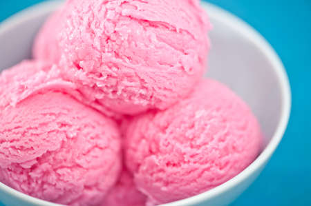 Raspberry ice cream cup over bBLUE backgroundの写真素材