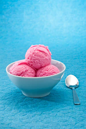 Raspberry ice cream cup over bBLUE backgroundの写真素材