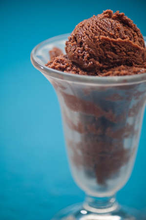 Chocolate ice cream cup over blue backgroundの写真素材