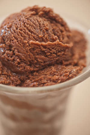 Chocolate ice cream cup over beige backgroundの写真素材