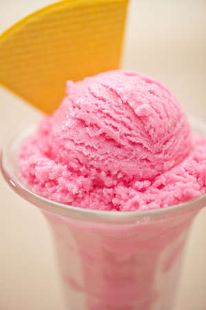 Raspberry ice cream in a tall glassの写真素材