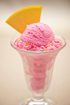 Raspberry ice cream in a tall glassの写真素材