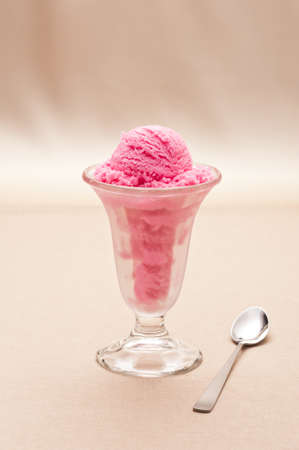 Raspberry ice cream in a tall glassの写真素材