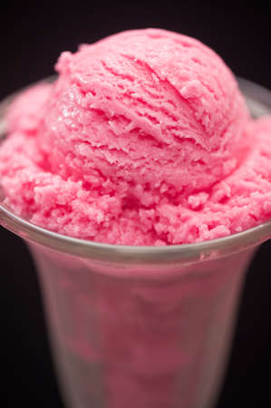 Raspberry ice cream in a tall glassの写真素材