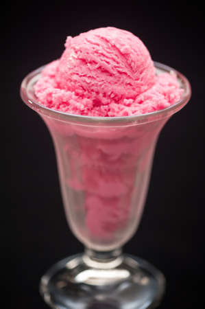 Raspberry ice cream in a tall glassの写真素材